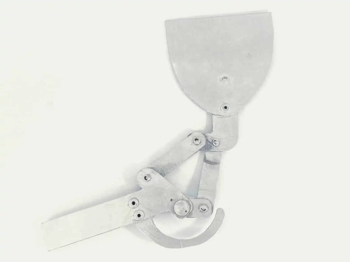 Riveted together pieces of sheet metal illustrating the movements of a knee joint prosthesis