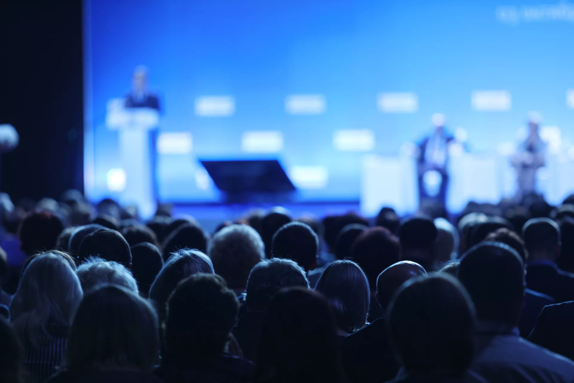 Rear view of audience in a conference hall.